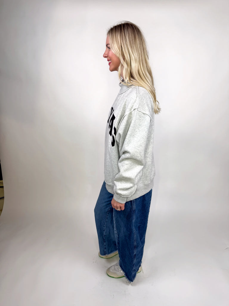 model wearing reversible texas sweatshirt with pink TX and gray TEXAS sides