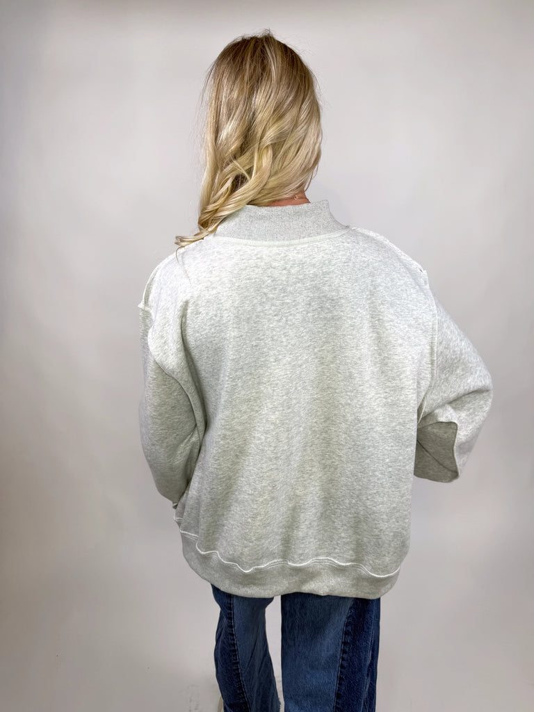 model wearing reversible texas sweatshirt with pink TX and gray TEXAS sides