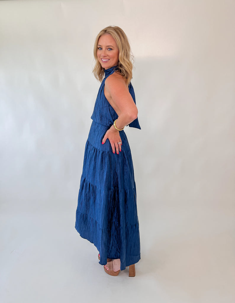 Navy halter maxi dress with open back and tiered silhouette