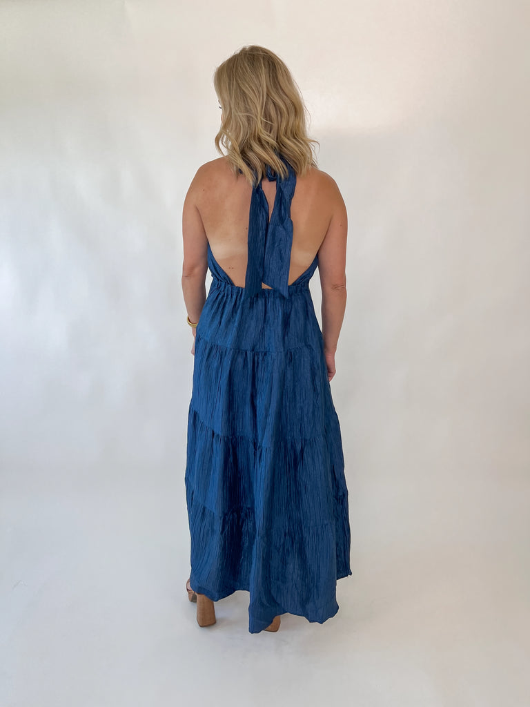 Navy halter maxi dress with open back and tiered silhouette