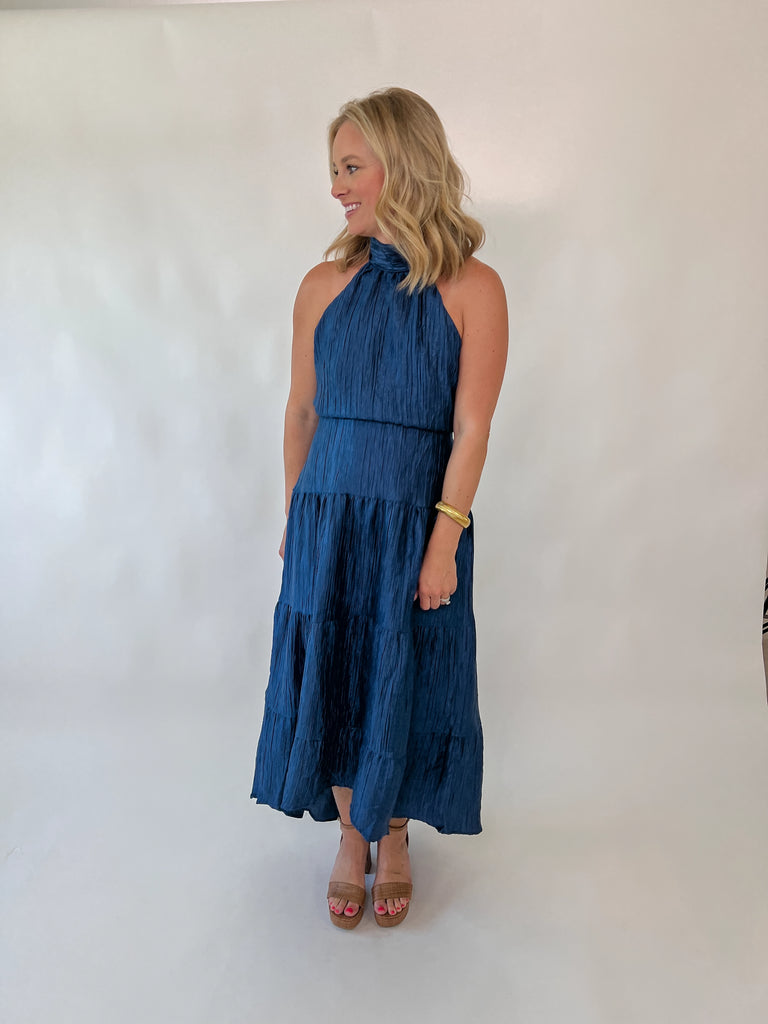 Navy halter maxi dress with open back and tiered silhouette