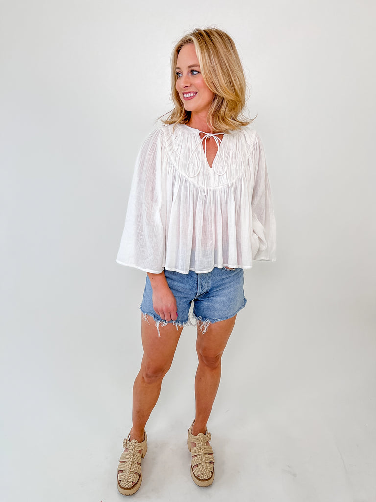 White smocked blouse with bell sleeves and keyhole tie neckline – boutique style top