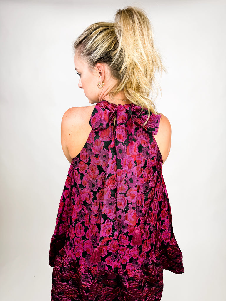 model wearing The Juliette Tassel Dress in magenta floral jacquard with tassel tie back
