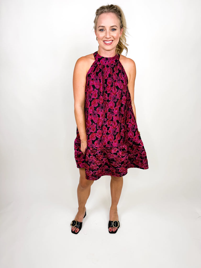 model wearing The Juliette Tassel Dress in magenta floral jacquard with tassel tie back