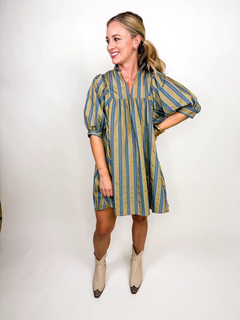 The Marlowe Stripe Dress featuring blue and camel vertical stripes with a ruffled neckline and puff sleeves
