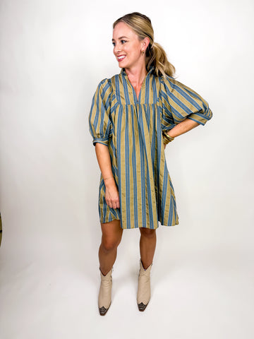 The Marlowe Stripe Dress featuring blue and camel vertical stripes with a ruffled neckline and puff sleeves