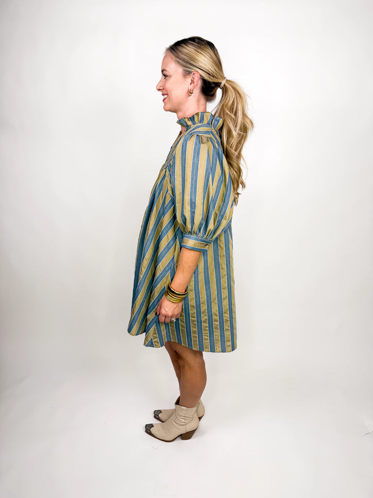 The Marlowe Stripe Dress featuring blue and camel vertical stripes with a ruffled neckline and puff sleeves
