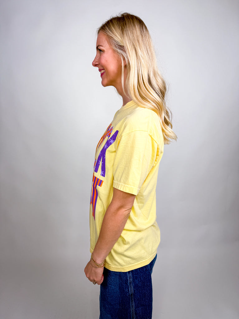 Woman wearing yellow Trick and Treat Comfort Colors Halloween graphic tee