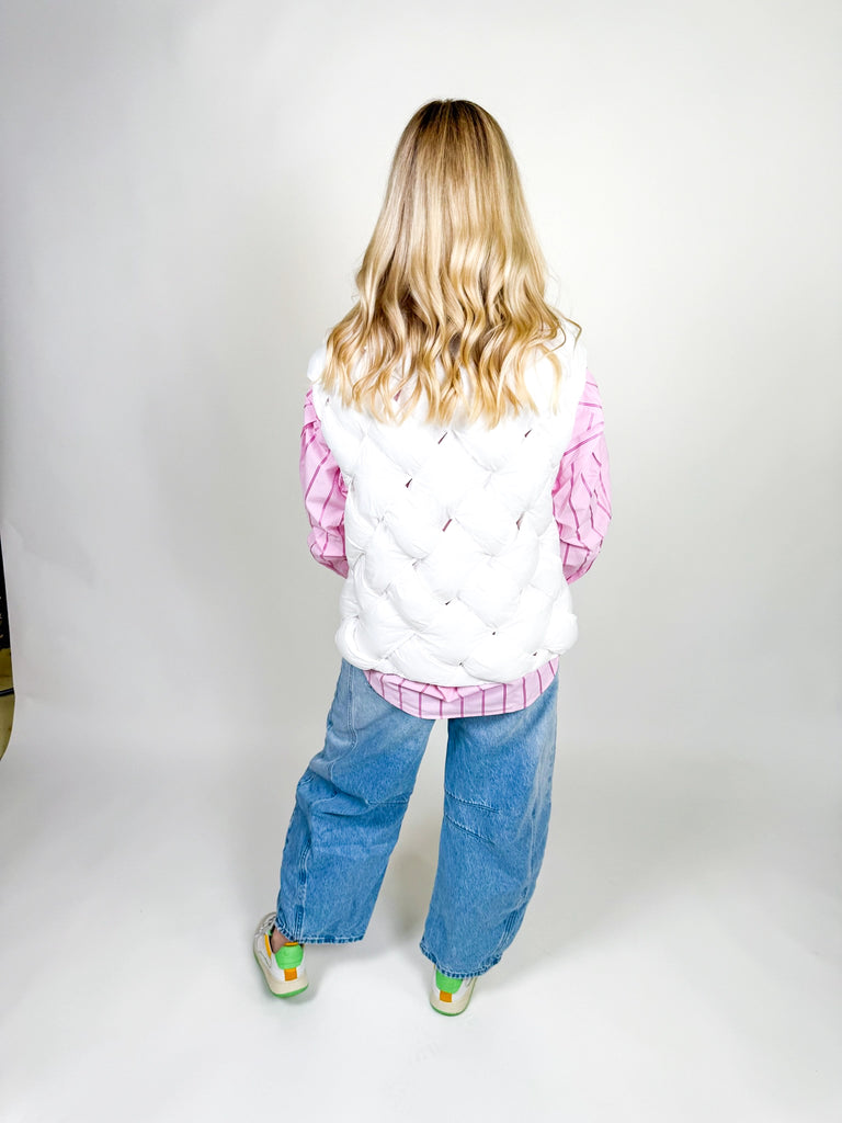 Woman wearing white quilted puffer vest