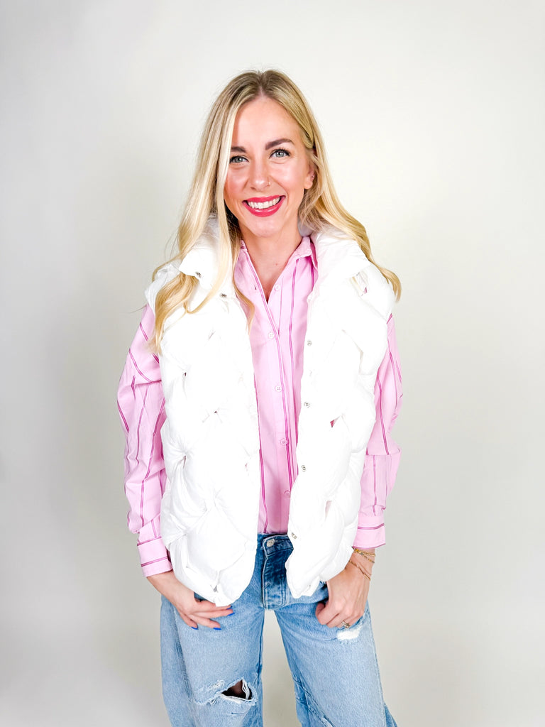 Woman wearing white quilted puffer vest