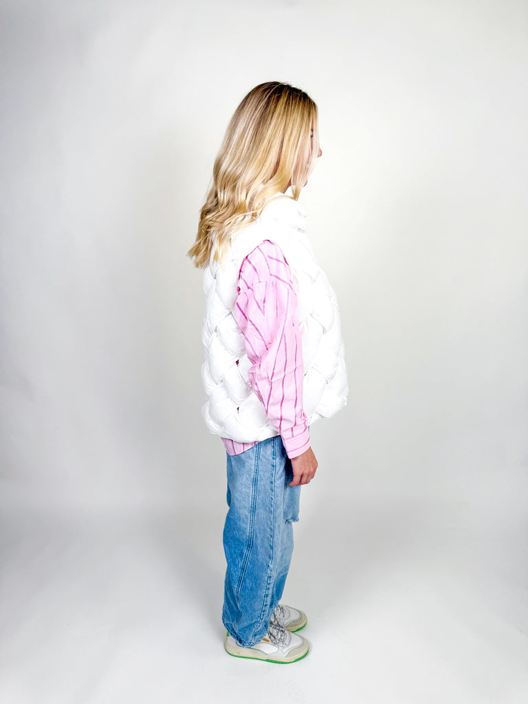 Woman wearing white quilted puffer vest