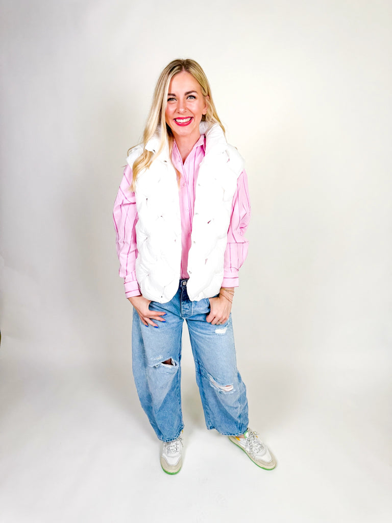 Woman wearing white quilted puffer vest